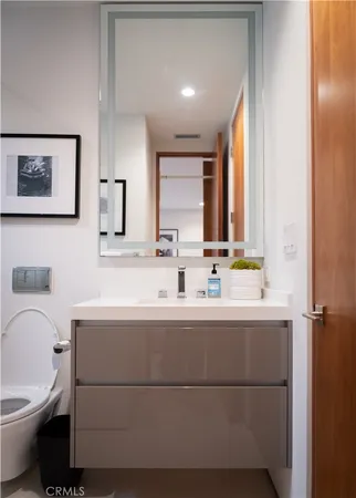 a bedroom with a bed and painting on the wall