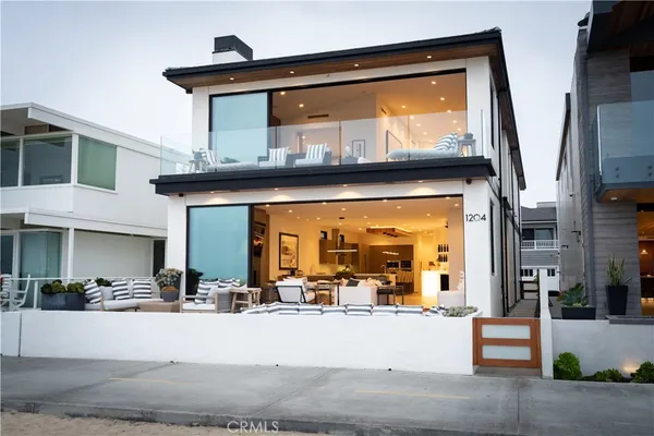 a view of living room with floor to ceiling window and dining room