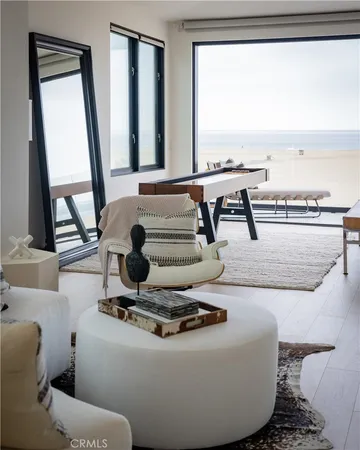 a living room with furniture and floor to ceiling window