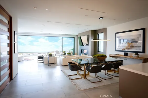 a living room with furniture and large windows