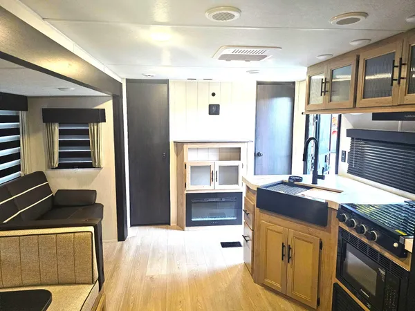 a kitchen with kitchen island granite countertop a stove and a sink