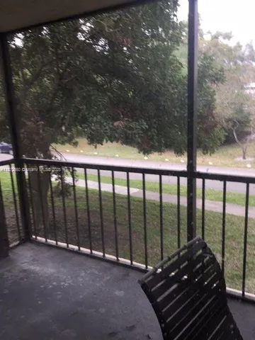 a balcony view with a yard