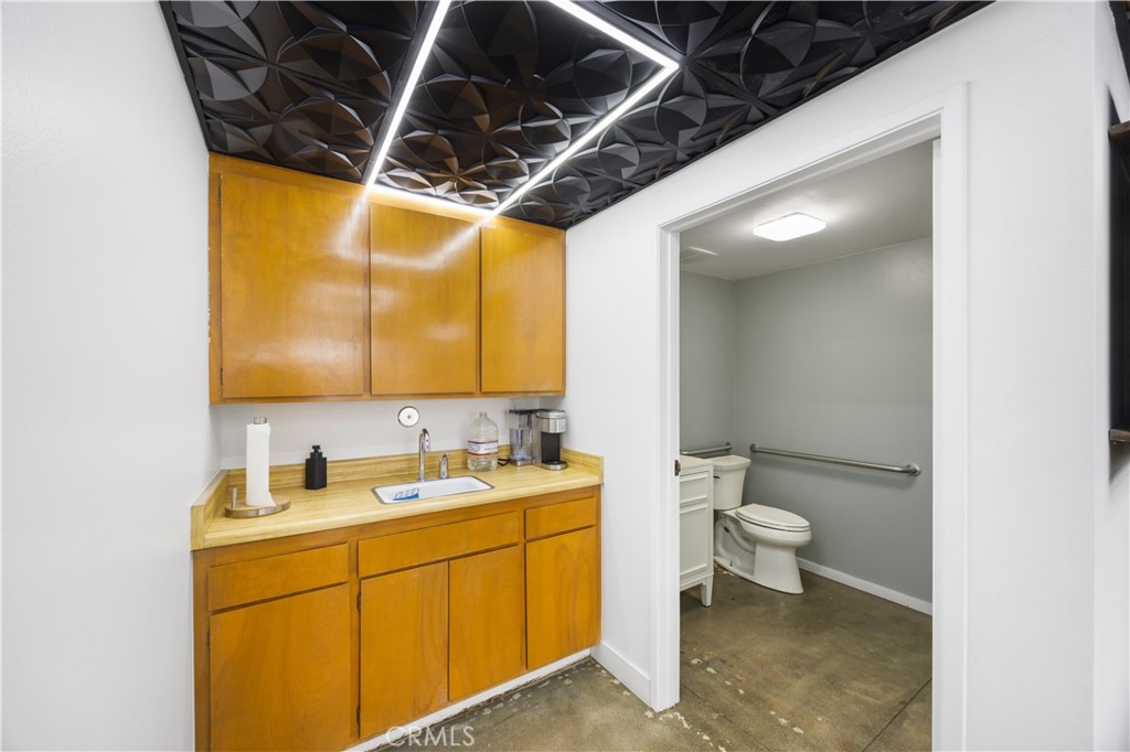 14128 Paramount Boulevard Paramount, CA 90723 - Photo 25 of 42 a bathroom with a toilet sink and mirror