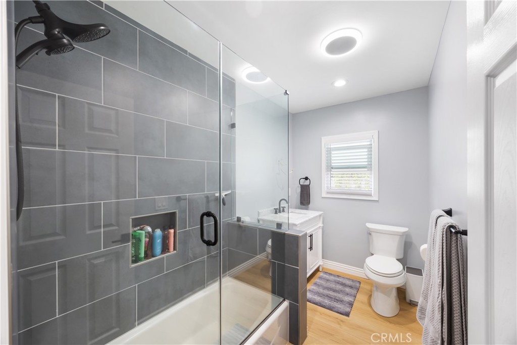 14128 Paramount Boulevard Paramount, CA 90723 - Photo 30 of 42 a bathroom with a toilet a sink and mirror