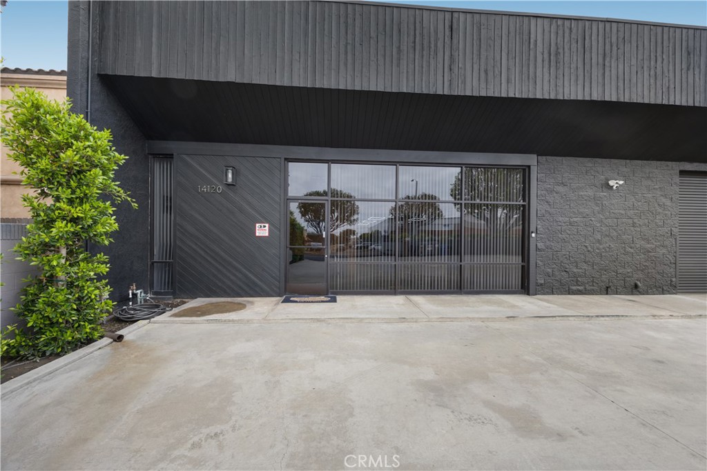 14128 Paramount Boulevard Paramount, CA 90723 - Photo 3 of 42 a black and white building with trees in the background