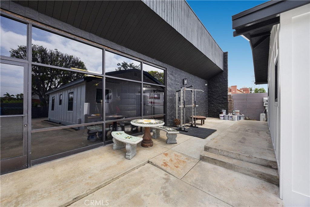 14128 Paramount Boulevard Paramount, CA 90723 - Photo 5 of 42 a view of a patio with table and chairs and potted plants