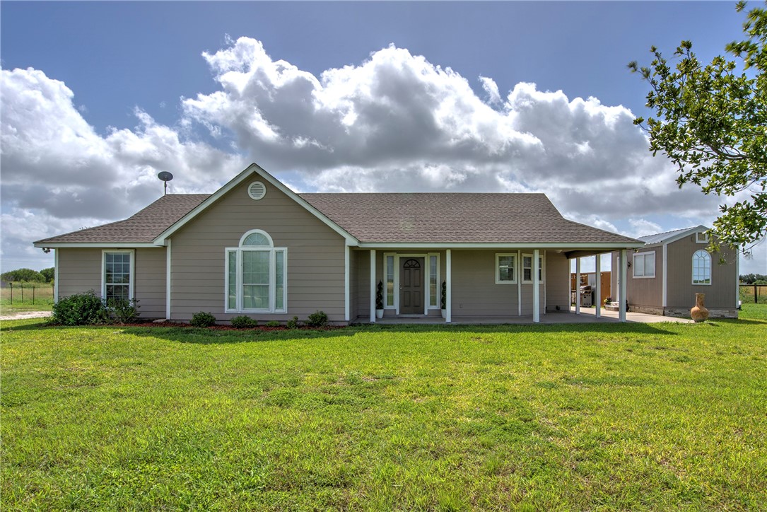 9386 Private Road 2155 Sinton, TX 78387 - Photo 1 of 1 a view of a house with a yard and a large tree