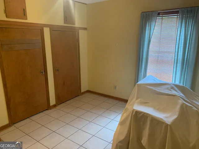 a bedroom with a bed and wooden cabinets
