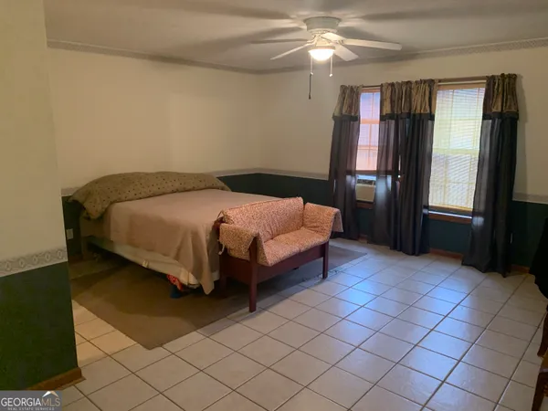 a spacious bedroom with a bed and window