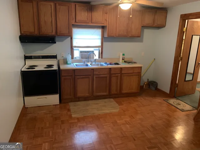 a kitchen with sink cabinets and appliances
