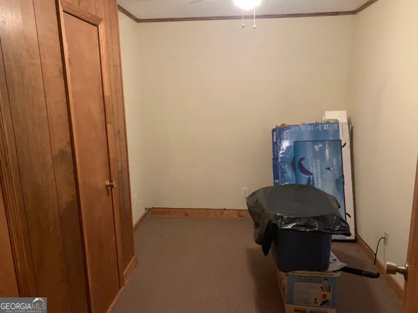 a room with a chair and wooden door
