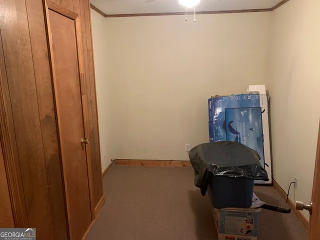 a room with a chair and wooden door