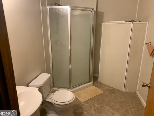 a bathroom with a toilet and a shower