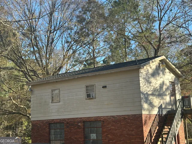 a view of a house with a large tree