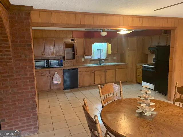 a kitchen with stainless steel appliances kitchen island granite countertop a sink and cabinets