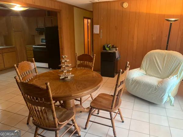 a dining room with furniture and wooden floor