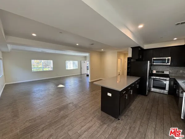 a kitchen with wooden cabinets and a sink