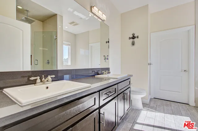 a bathroom with a sink double vanity and a mirror