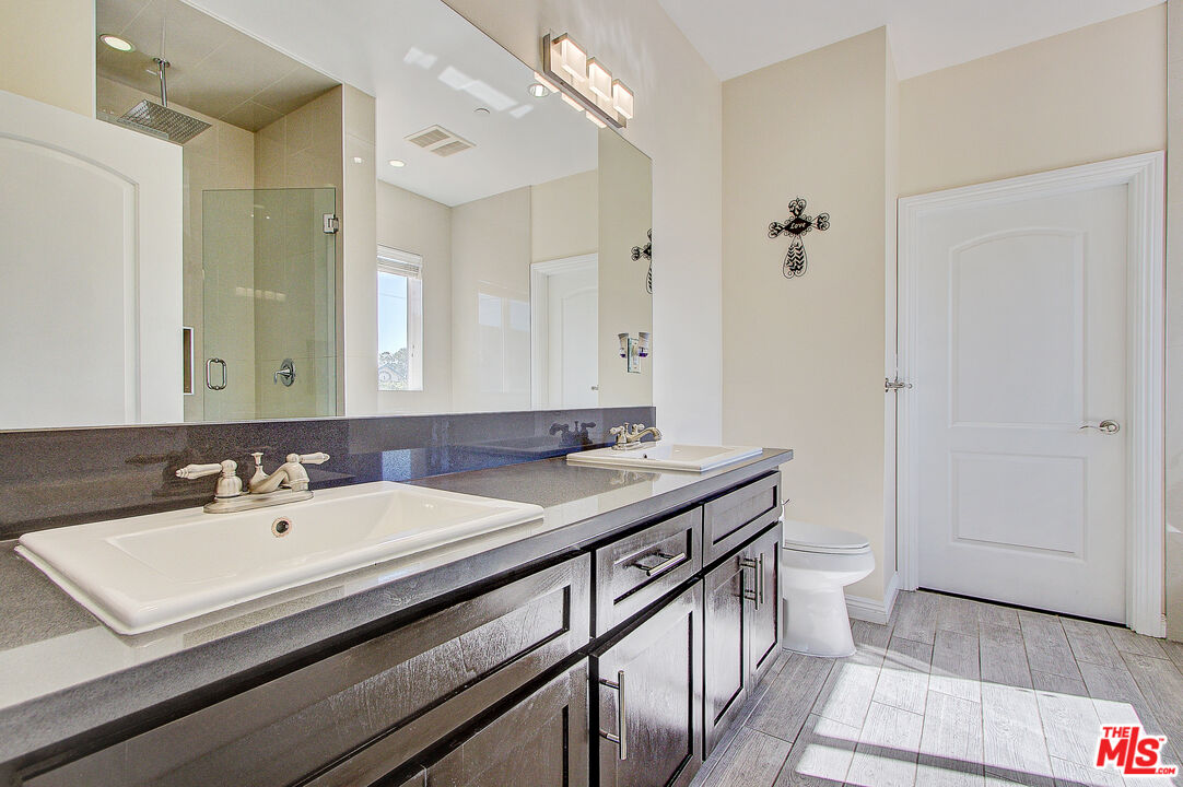 24842 Frampton Avenue Harbor City, CA 90710 - Photo 11 of 26 a bathroom with a sink double vanity and a mirror