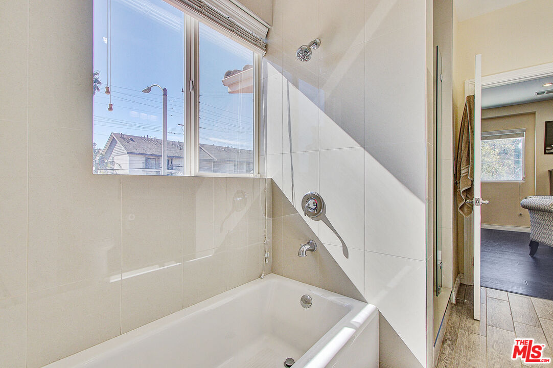 24842 Frampton Avenue Harbor City, CA 90710 - Photo 12 of 26 a bathroom with a tub sink and mirror