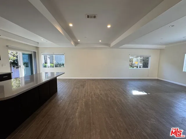 a view of a living room a window and wooden floor