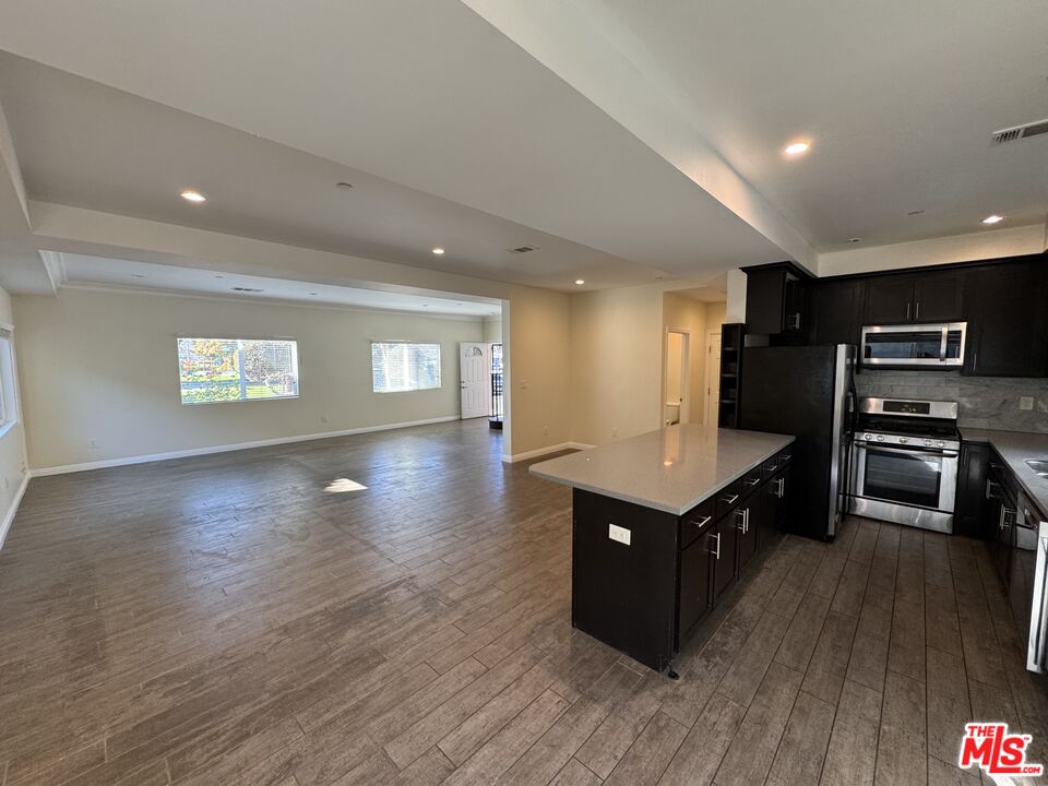 24842 Frampton Avenue Harbor City, CA 90710 - Photo 17 of 26 a kitchen with wooden cabinets and a sink