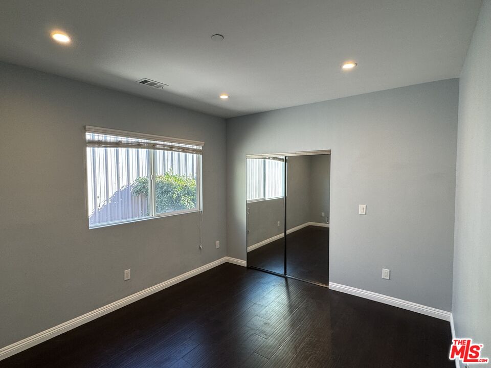 24842 Frampton Avenue Harbor City, CA 90710 - Photo 19 of 26 an empty room with wooden floor and windows