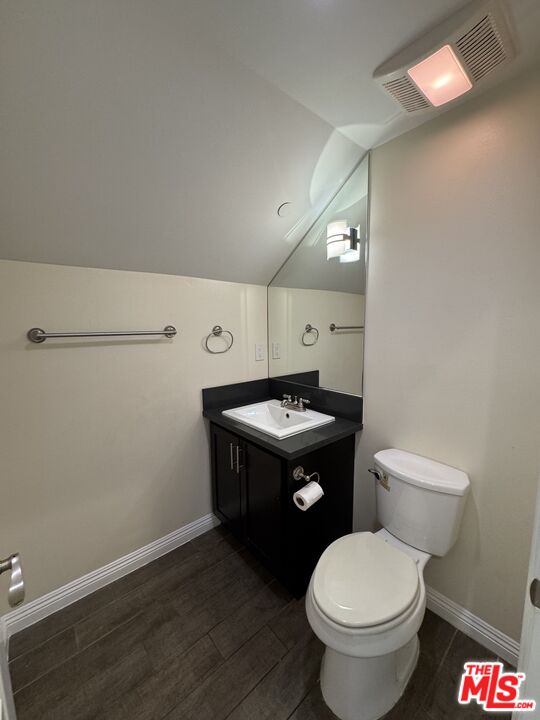 24842 Frampton Avenue Harbor City, CA 90710 - Photo 20 of 26 a bathroom with a granite countertop toilet and a mirror