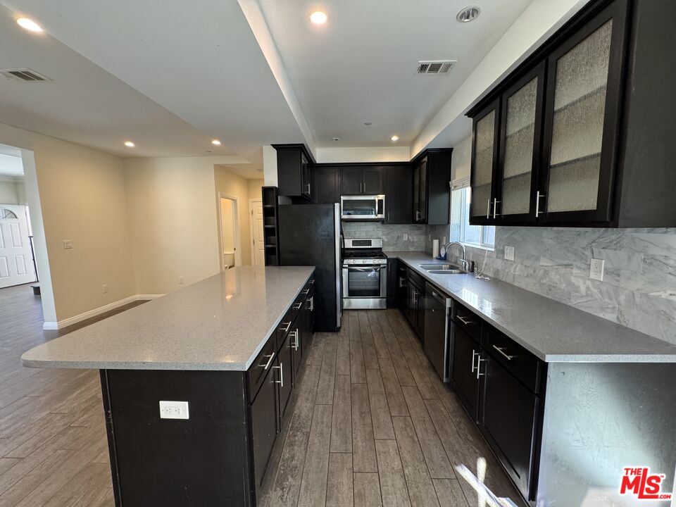 24842 Frampton Avenue Harbor City, CA 90710 - Photo 21 of 26 a kitchen with stainless steel appliances a stove a sink a refrigerator and a oven