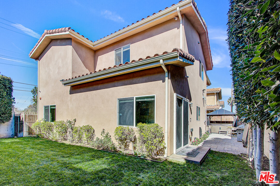 24842 Frampton Avenue Harbor City, CA 90710 - Photo 3 of 26 a front view of a house with a yard