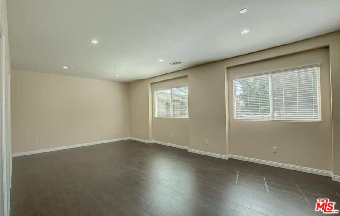 24842 Frampton Avenue Harbor City, CA 90710 - Photo 4 of 26 an empty room with wooden floor and windows
