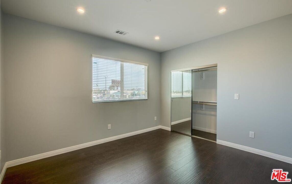24842 Frampton Avenue Harbor City, CA 90710 - Photo 5 of 26 an empty room with wooden floor and closet