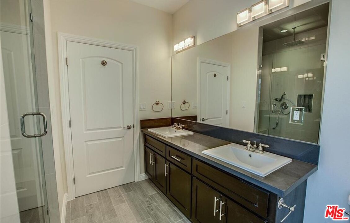24842 Frampton Avenue Harbor City, CA 90710 - Photo 7 of 26 a bathroom with a sink double vanity and a mirror