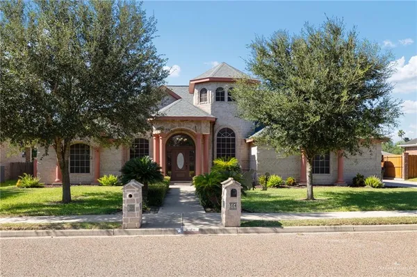 a front view of a house with a yard garage and outdoor seating