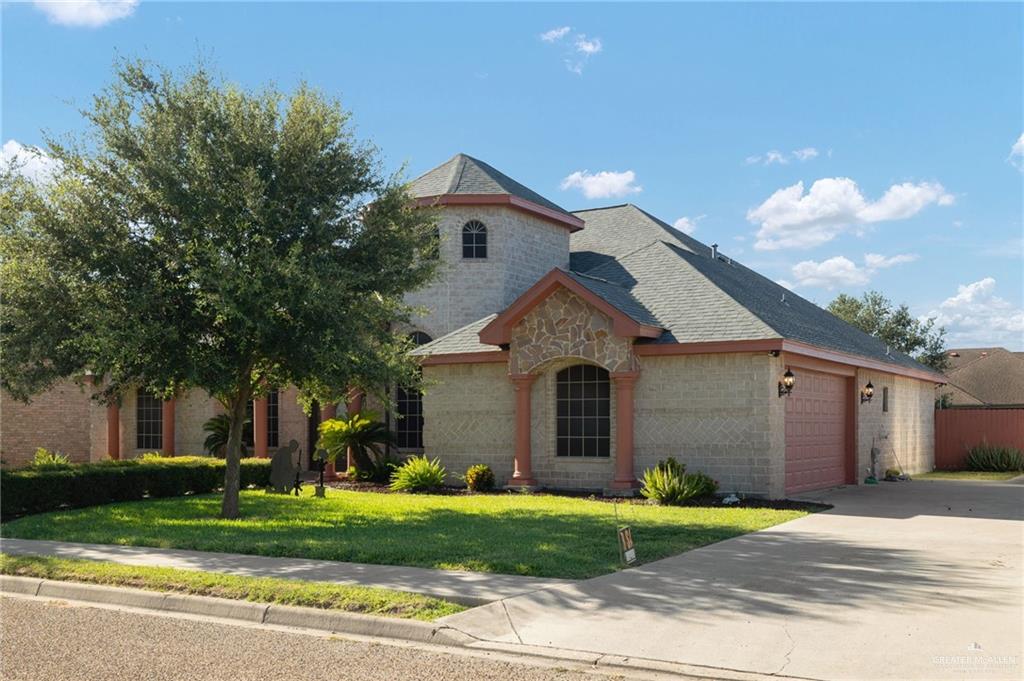504 Orchard Court Weslaco, TX 78596 - Photo 2 of 24 a front view of a house with a yard