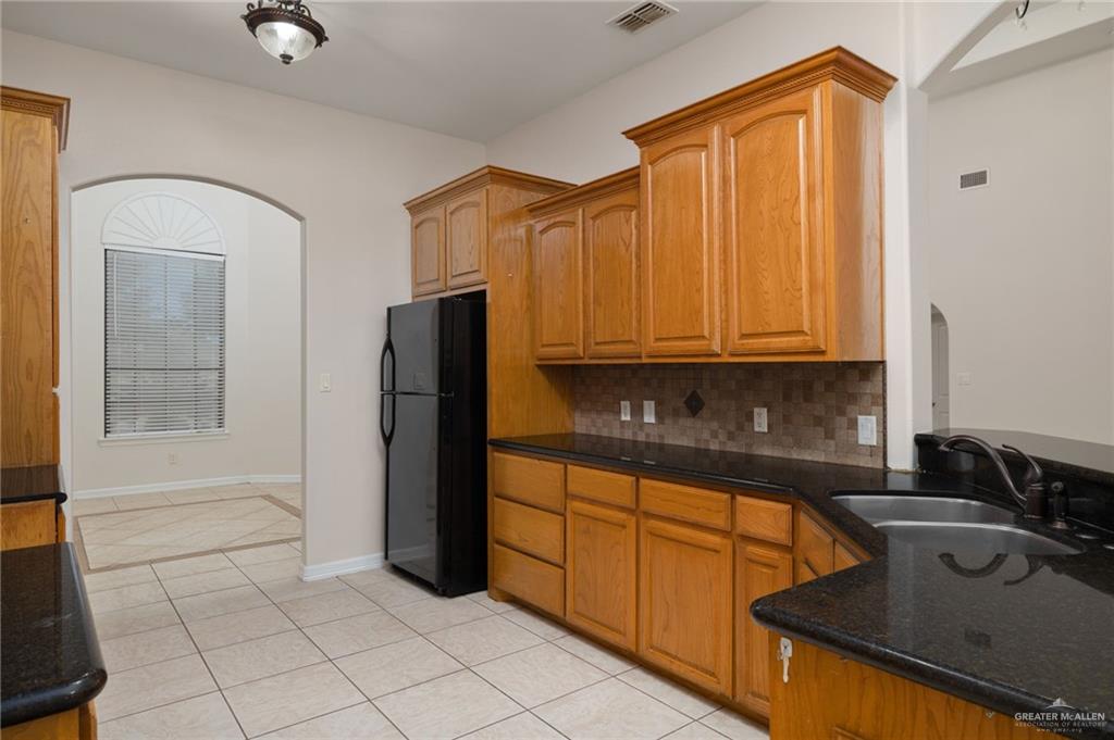 504 Orchard Court Weslaco, TX 78596 - Photo 10 of 24 a kitchen with stainless steel appliances granite countertop a refrigerator and a sink
