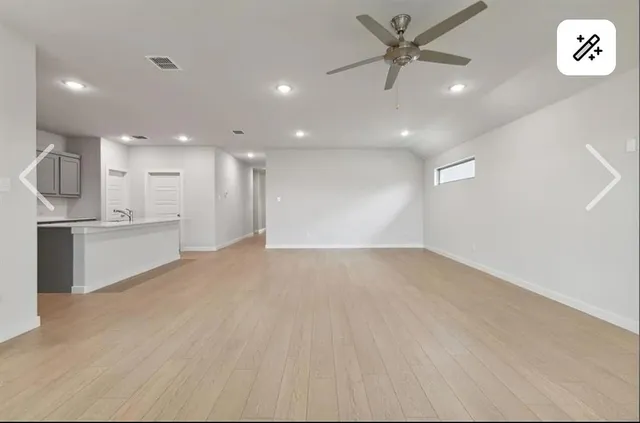 a view of a kitchen with a sink and a refrigerator