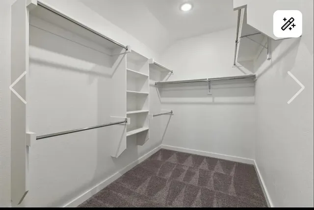 a view of walk in closet with empty racks