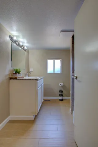 a kitchen with a sink and a mirror