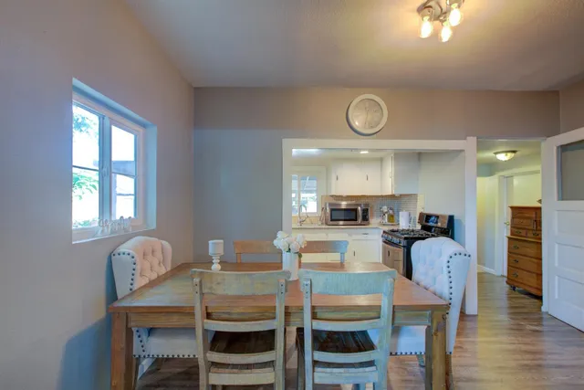 a view of a dining room with furniture and wooden floor