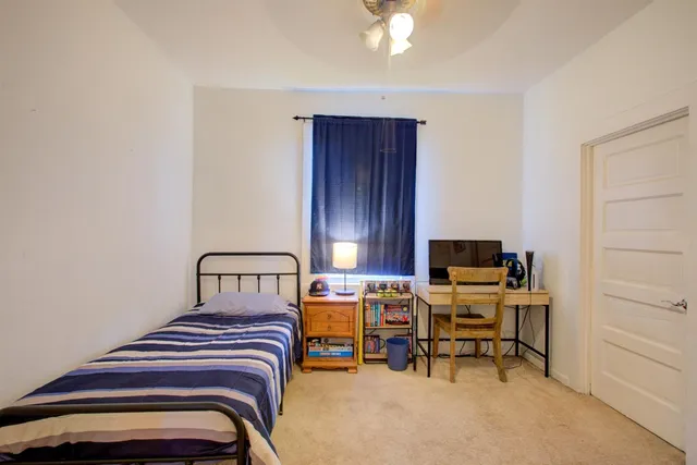 a bedroom with furniture and a chandelier