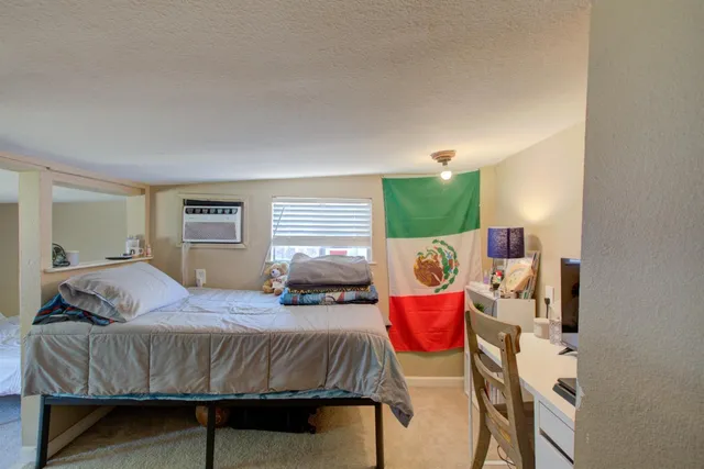 a bedroom with a bed and window