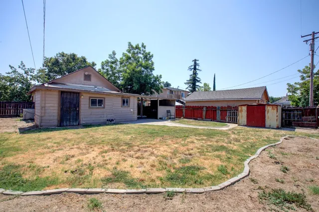 a backyard of a house with table and chairs