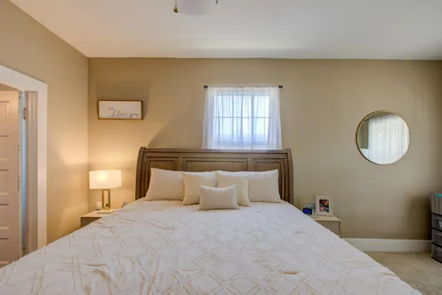 a bedroom with a bed and window