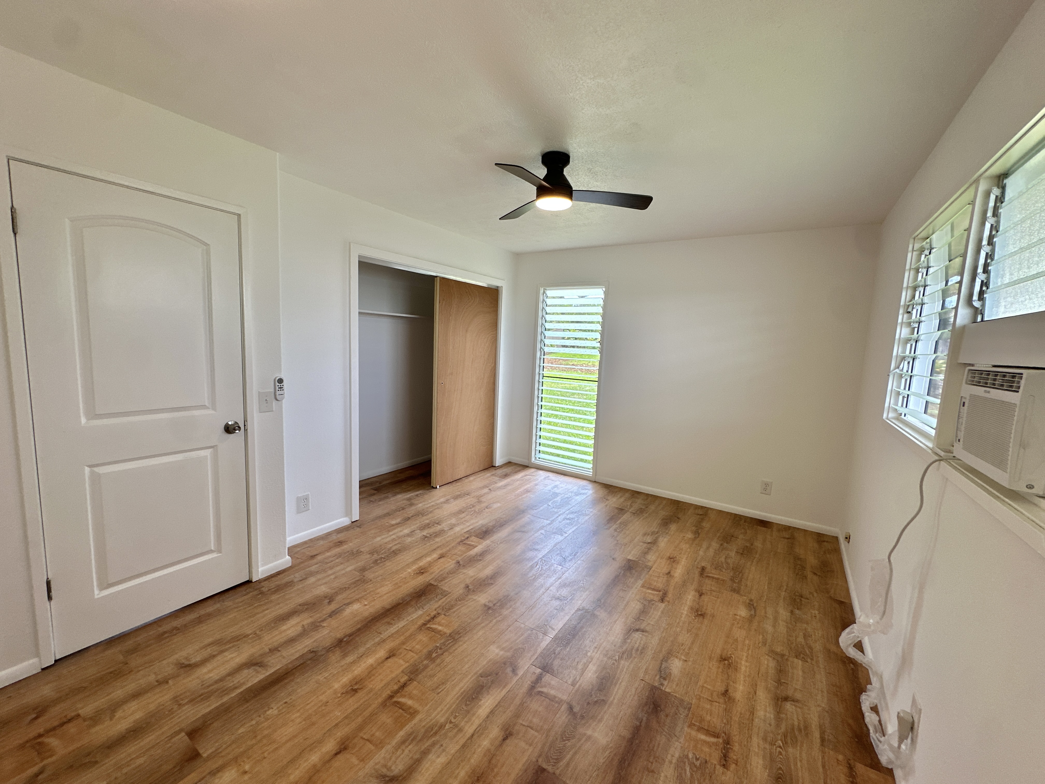164 Likeke Street Hilo, HI 96720 - Photo 14 of 29 a view of an empty room with wooden floor and a window