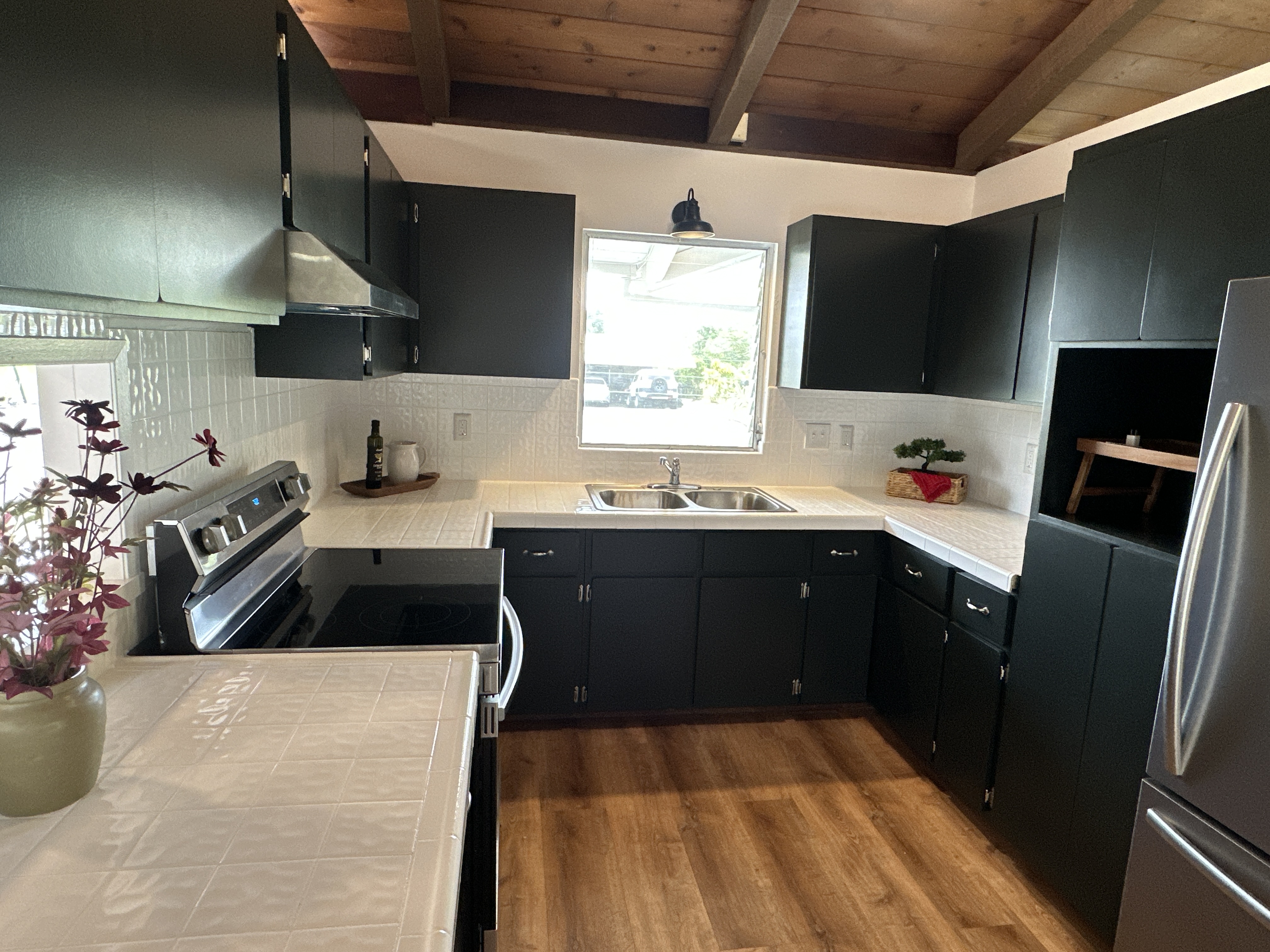 164 Likeke Street Hilo, HI 96720 - Photo 7 of 29 a kitchen with a sink a stove and refrigerator