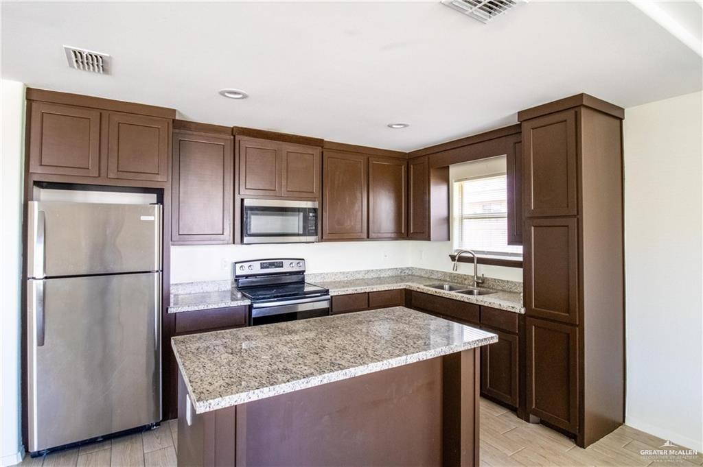 2118 Taxco Court, Unit 2 Edinburg, TX 78542 - Photo 2 of 13 a kitchen with a refrigerator stove and sink
