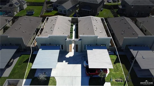 an aerial view of a house with a terrace seating area