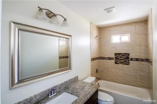 an empty room with closet and fan