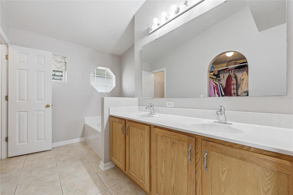23152 Northwest 11th Road Newberry, FL 32669 - Photo 18 of 31 a bathroom with a sink and a mirror